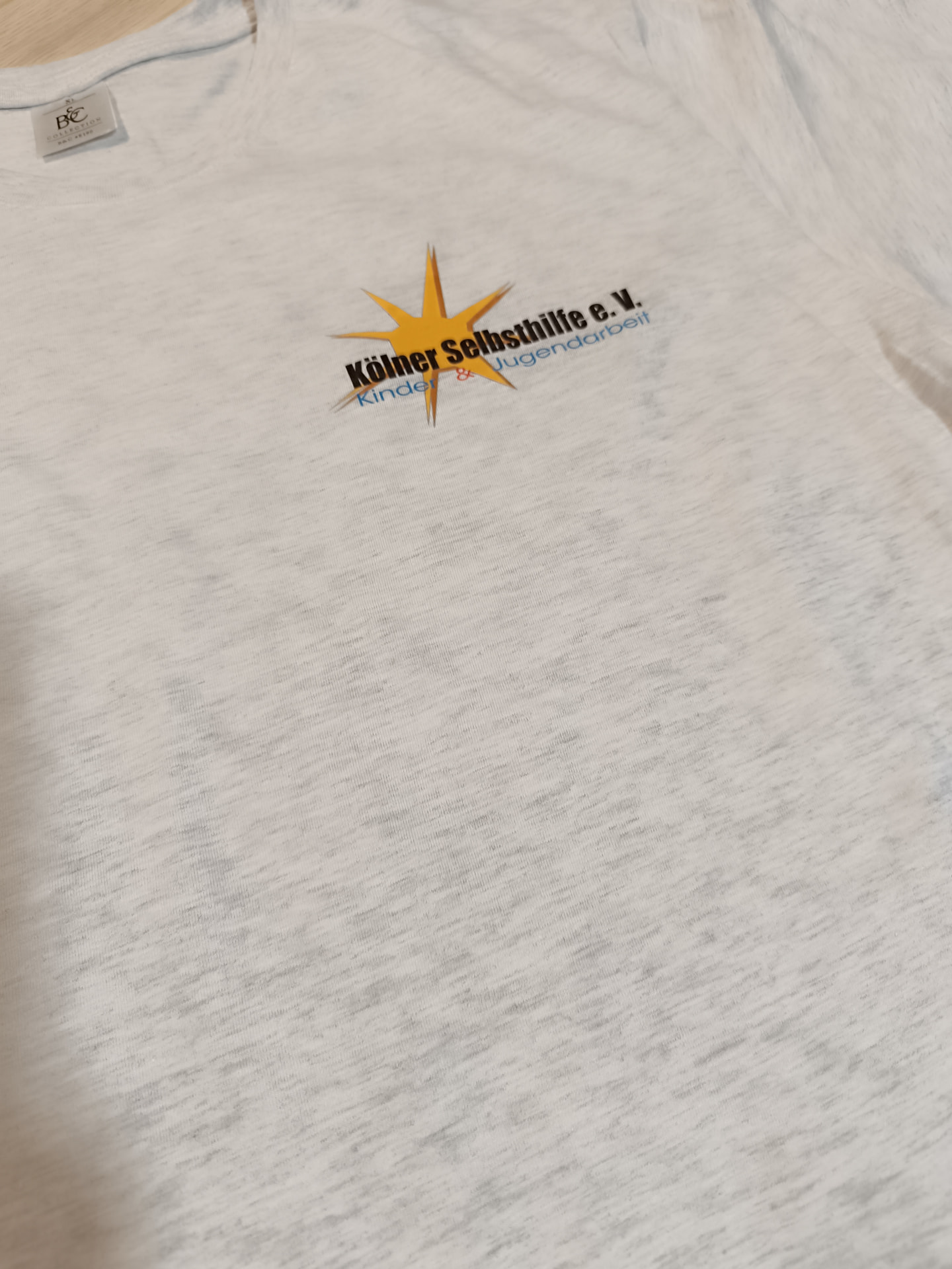 Graumeliertes T-Shirt mit kleinem Logo auf der Brust